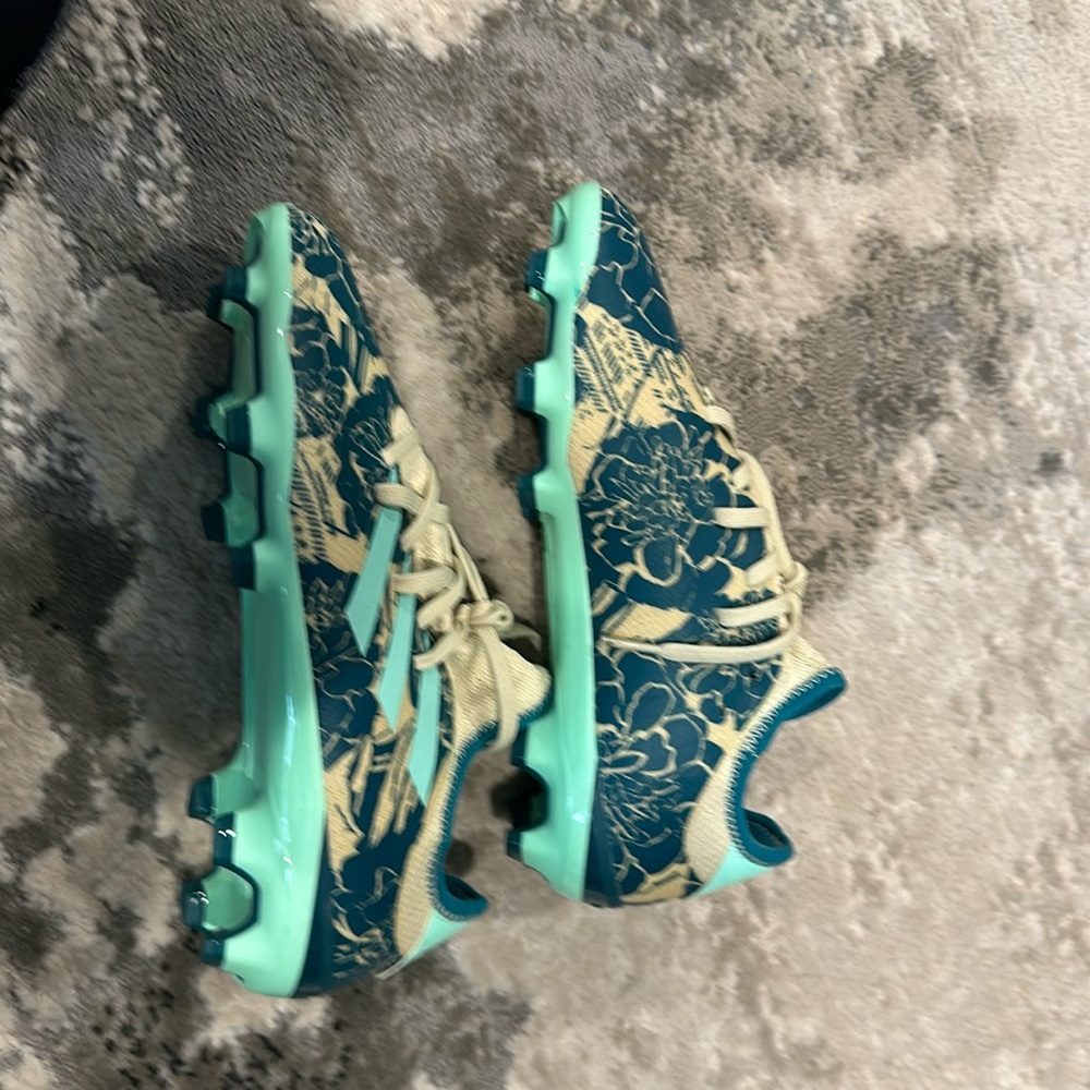 Blue beige and green adidas cleats